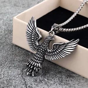 Stainless steel eagle pendant detail shot showing intricate feather texture and polished metallic shine.