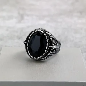 Vintage stainless steel men's ring featuring a bold black faceted glass stone and detailed design.