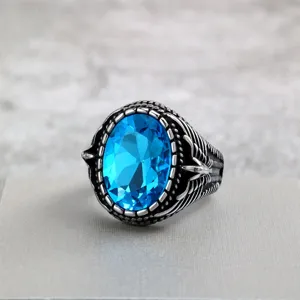 Vintage stainless steel men ring with blue faceted stone and detailed wing carvings design.