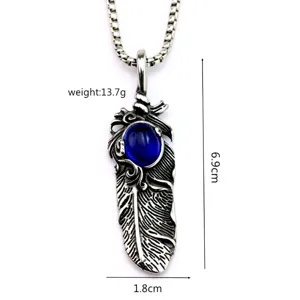 Detailed view of vintage silver feather pendant with blue stone, showing size and weight.