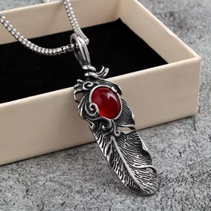 Stainless steel feather pendant necklace detail, vintage style men jewelry piece with red stone.