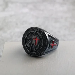 Close-up detail of vintage stainless steel men ring with Templar cross shield engraving.