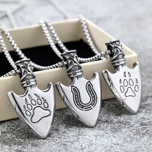 Close-up of stainless steel arrow pendant necklace with unique animal paw and horseshoe details.