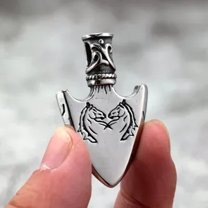 Detail shot of stainless steel arrow pendant with retro horse head engraving and polish.