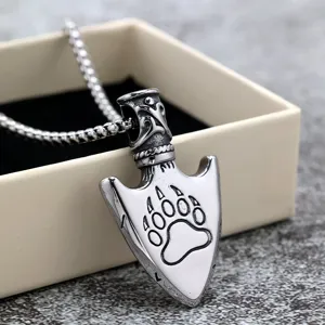 Detailed view of stainless steel arrowhead pendant featuring a bear claw engraving with a chain.