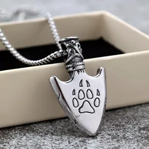 Stainless steel arrowhead pendant detail, retro Nordic paw print necklace close-up view