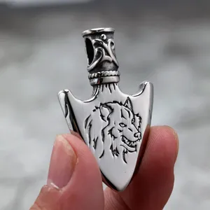 Stainless steel wolf arrowhead pendant detail showcasing exquisite engraved pattern and polished finish.