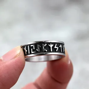 Detailed view of a Nordic retro stainless steel men's ring featuring solid Viking rune engravings.