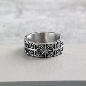 Close up detail view of vintage stainless steel men ring featuring distressed pirate anchor motif.