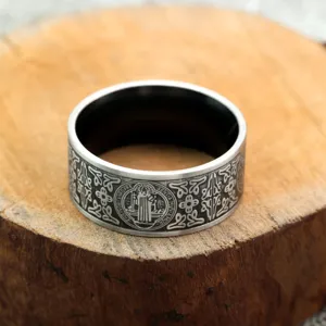 Detailed close-up of retro stainless steel men's ring featuring intricate religious cross engravings.