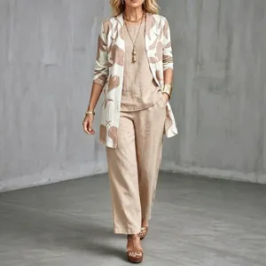 Detailed view of the stylish three-piece linen outfit with printed cardigan and trousers.