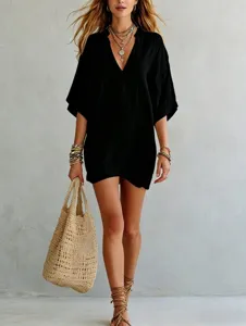 Detail shot of a black V-neck loose tunic top, perfect for resort vacation style wear.