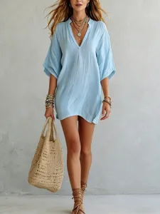 Light blue V-neck loose casual tunic top, detailed lifestyle view showing relaxed resort style.