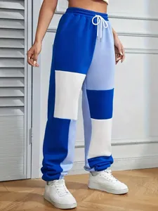 Casual colorblock sweatpants detail showing contrast patchwork design, adjustable drawstring waist.