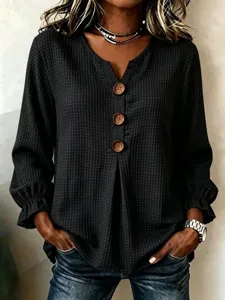 Detailed view of the women's waffle knit long sleeve top with V-neck and decorative buttons.
