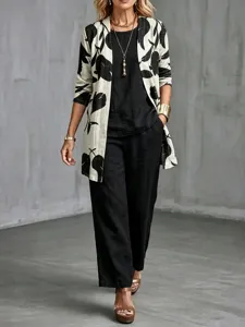 Detail view of the stylish three-piece outfit featuring a floral print cardigan and black set.