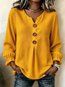 Women's V-neck waffle knit long sleeve blouse with buttons and ruffle cuffs, casual top.