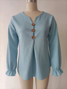 Light blue waffle knit detail, V-neckline with wooden buttons and cute ruffled cuffs.