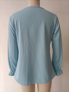 Back view detail of light blue waffle knit long sleeve top with cute ruffle cuffs for women.