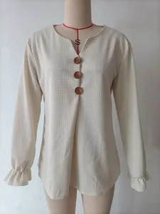Detailed view of women's waffle knit long sleeve V-neck top with cute ruffle cuffs.