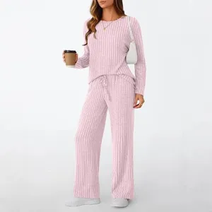 Casual pink ribbed two-piece loungewear set detail view on model with a coffee cup.