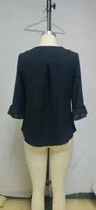 Women's casual solid color blouse featuring a stylish back pleat and cute ruffled sleeves.