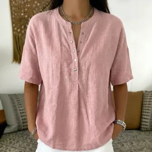 Close-up detail of casual V-neck button-down short sleeve top in soft pink color.