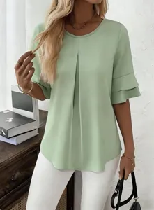 Detail shot of women's light green ruffle half sleeve blouse with pleated front.