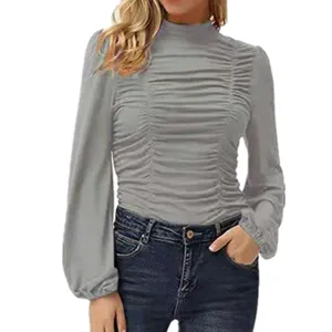 Detail view of ruched mock neck long sleeve top detail showing elegant lantern sleeves