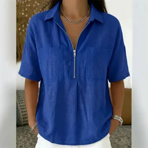 Detail view of the blue short sleeve zip V-neck shirt with chest pockets and linen texture.