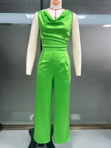 Green satin sleeveless cowl neck jumpsuit detail with elegant drape and chic wide leg styling.