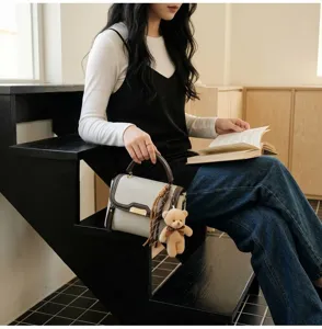 Retro women handbag detail scene on stairs with cute bear pendant and tassel decoration style.