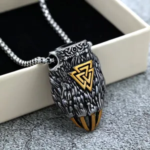 Close-up of stainless steel Viking bear claw pendant with golden Valknut symbol detail on chain.