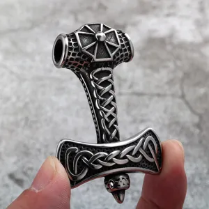 Detailed shot of stainless steel Viking Thor hammer pendant featuring intricate Celtic knotwork.