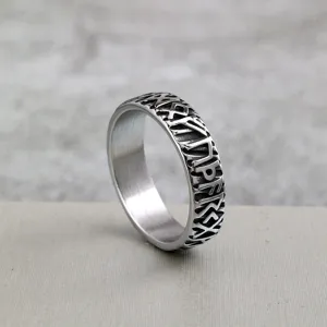 Detailed close-up view of the vintage stainless steel ring featuring intricate Viking rune carvings.