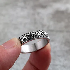Close-up detail of stainless steel Viking rune ring, retro engraved men jewelry band.