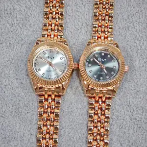 Rose gold quartz women watch with rhinestone dial and metal link bracelet, detail view.