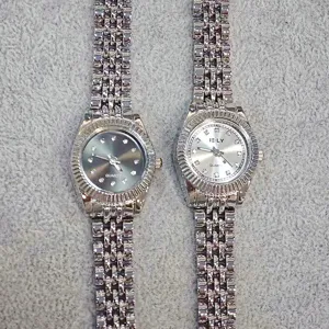 Detailed view of women quartz watches featuring sparkling rhinestone markers and metal bracelets.