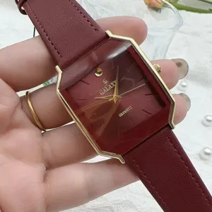 Detailed view of the vintage quartz watch with a unique hexagonal gold bezel and burgundy dial.