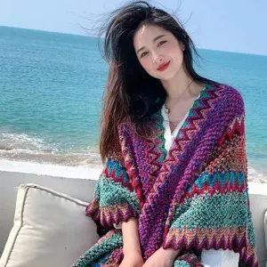 Colorful knitted ethnic style shawl detail showing vibrant wave pattern and cozy texture.