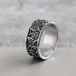 Stainless steel vintage Viking ring close up view, detailed Celtic knot metal band design.