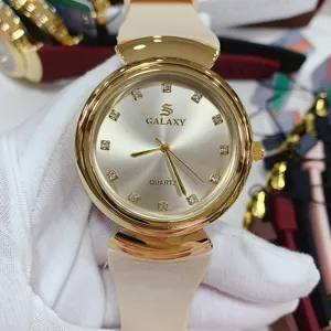 Detailed view of GALAXY women quartz watch, gold case with rhinestone dial and beige silicone strap.