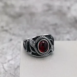 Vintage retro stainless steel men's ring featuring twin snake wrap and a red gemstone.
