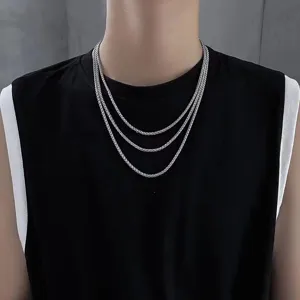 Close-up detail of multi-layered stainless steel dragon bone chain necklace for men fashion.