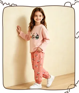 Charming toddler girl outfit detail, pink graphic sweatshirt and floral sweatpants scene.