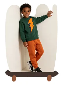 Detailed view of the boys stylish green sweatshirt featuring a striking orange lightning bolt design.