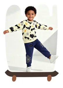 Detailed view of boys Halloween sweatshirt and blue sweatpants set featuring bat and web prints.