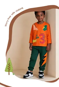 Details of autumn kids cotton sweatshirt and sweatpants with cute dinosaur and lightning prints.