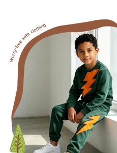 Detailed view of the green kids sweatshirt and pants set featuring vibrant orange lightning print.