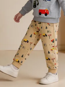 Kids casual cartoon car print joggers, comfy boys autumn trousers with elastic cuffs.
